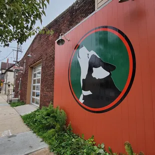a red building with a green and black sign