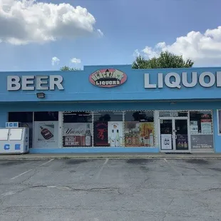 a blue building with a sign that says beer liquor