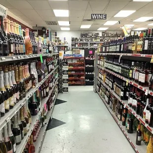a wide aisle of wine bottles