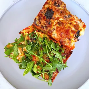 Sourdough Pizza Slices: Cheese + Garlic confit, ricotta, bell peppers, tomatoes, and arugula | $6 each