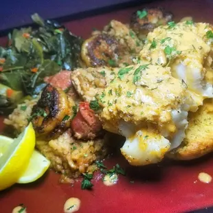Greens, jambalaya, crab crusted baked Chilean striped sea bass with lemon herb and garlic butter cream sauce