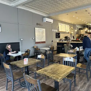 people sitting at tables in a cafe