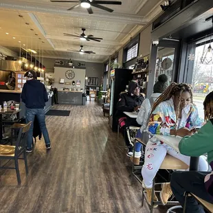people sitting at tables in a coffee shop
