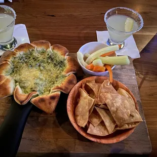 a wooden table with food and drinks