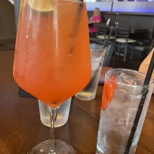 a glass of orange juice and a glass of lemonade
