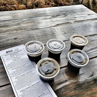 four cups of coffee on a picnic table