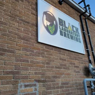 a sign on a brick wall