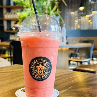 a smoothie in a plastic cup with a straw