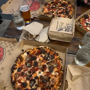 two pizzas and a glass of beer