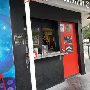 a red door and a black wall
