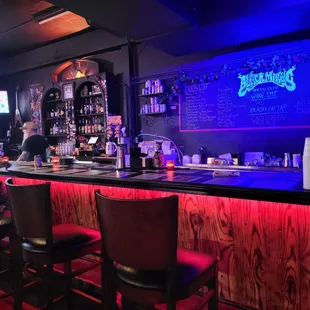 a bar with red stools