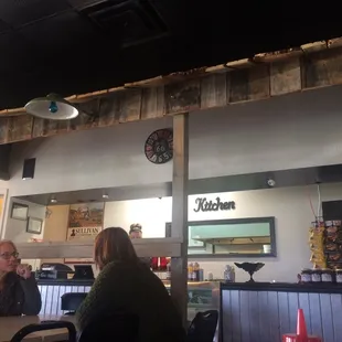 people sitting at tables in a restaurant