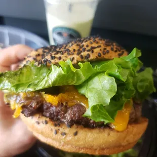 a hamburger with lettuce and cheese