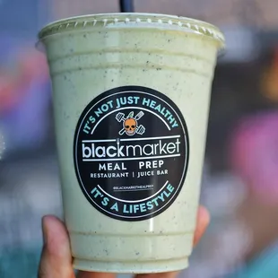 a hand holding a cup