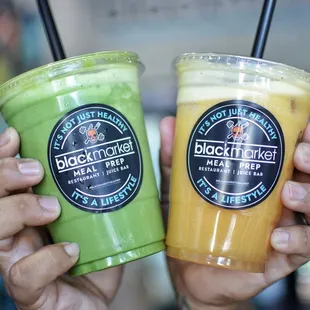 two people holding drinks