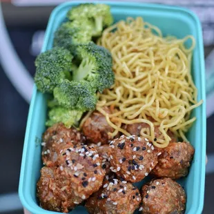 a person holding a container of food