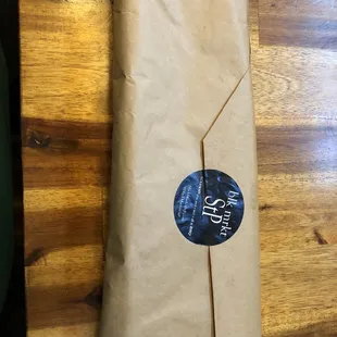 a brown paper bag with a sticker on it