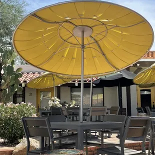 tables with yellow umbrellas