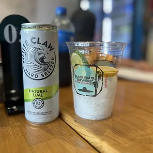 a can of lemonade and a glass of lemonade