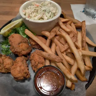 Fried oyster basket with french fries and coleslaw.