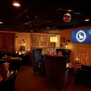 people sitting at tables in a dimly lit restaurant