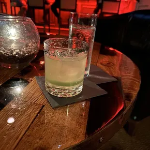 a drink in a glass on a wooden table
