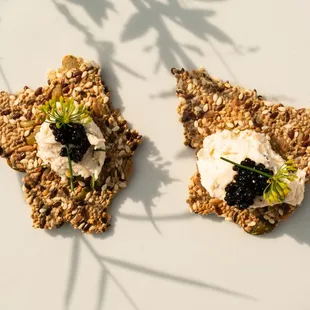 seeded cracker with salmon mousse, caviar, chive blossom