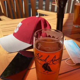 a glass of beer on a wooden table