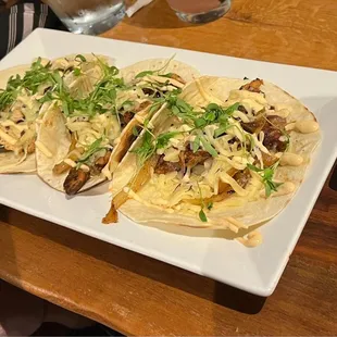 two tacos on a white plate
