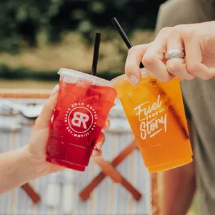 two people holding drinks
