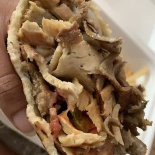 a hand holding a sandwich