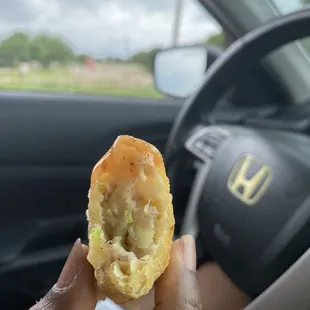 a person holding a piece of food in their hand