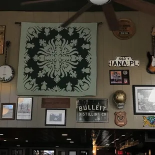 a ceiling fan and a variety of framed pictures