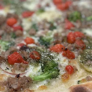 Finely sliced potatoes, Italian sausage, broccoli, and petite sweet peppers with a macadamia nut and basil pesto