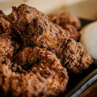 a plate of fried chicken with a side of ranch dressing