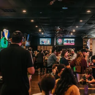 a large group of people eating and drinking
