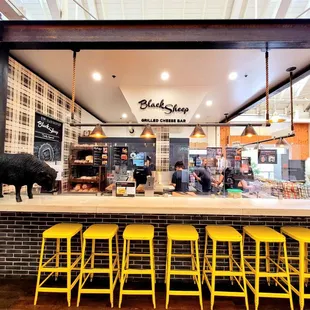 a counter with yellow stools