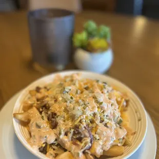 a plate of pasta with a side of broccoli