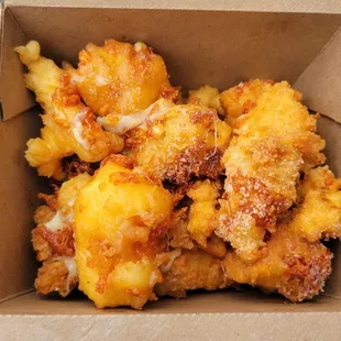 Pancake battered cheese curds with a side of syrup