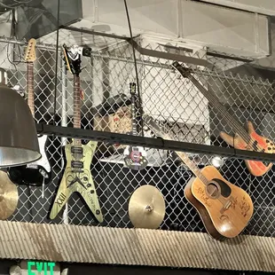 guitars and lamps hanging from the ceiling