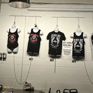 t - shirts hanging on a wall