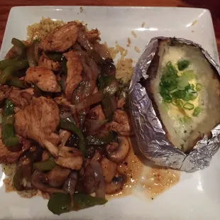 Teriyaki chicken over rice pilaf and baked potato with butter &amp; chives