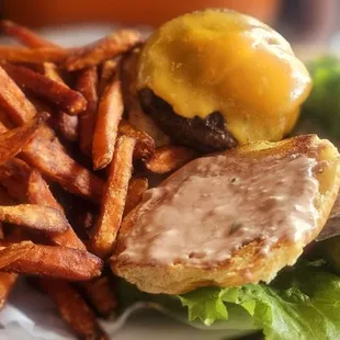 American burger w/ cheddar cheese and sweet potato fries. Looks great, but tastes ehhh. Seasoning would help...