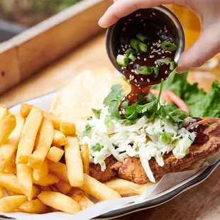 a plate of food with fries and coleslaw