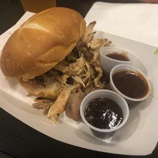 Pulled pork sandwich with three sauce choices: blueberry chipotle, CraftHaus Russian Emperoal Stout infused BBQ sauce, and house sauce