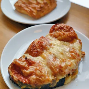 a slice of pizza on a white plate