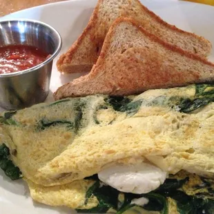 Spinach and goat cheese omlette with dry wheat toast and salsa.
