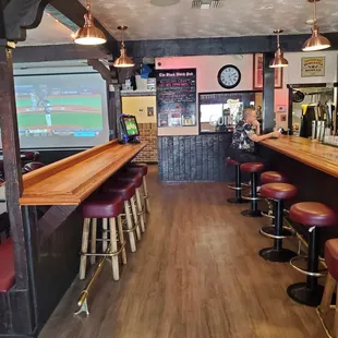 a bar with red stools
