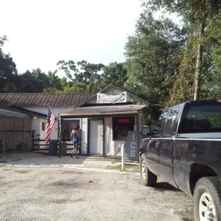 a pickup truck parked in front of a store