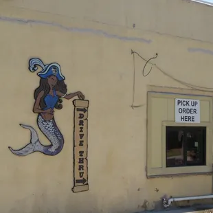  mermaid on the side of a building